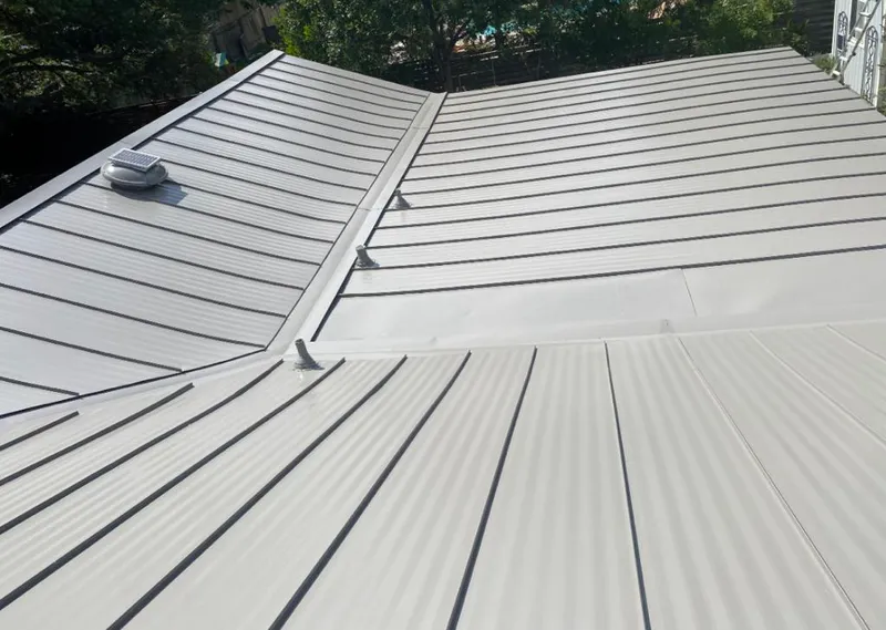 Solar attic fan installed on a metal roof for Roof Ventilation in Fort Gratiot